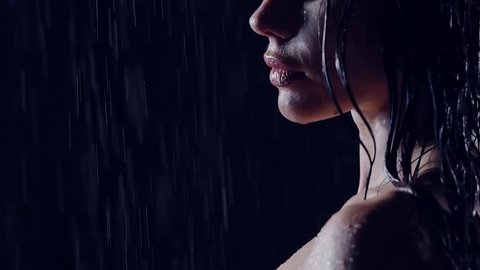 close-up, profile, sexy girls taking a bath. she showers in a dark room in the shower