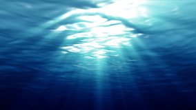 Underwater light filters down through blue water (Loop).