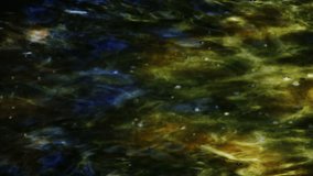 Light patterns on moving, moody water (Loop).