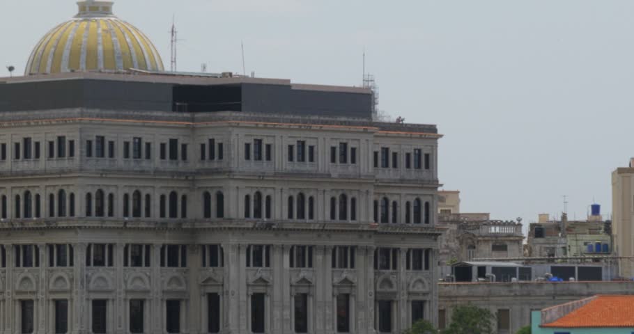 A high angle dolly establishing shot of the capitol dome in the old town section of Havana, Cuba.  	