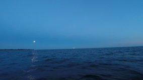 Sailboats sailing on water under moonlight of full moon on Lake Ontario, Toronto, Canada. Time lapse - Powered by Shutterstock - Get 15% off with code: PIKWIZARD15