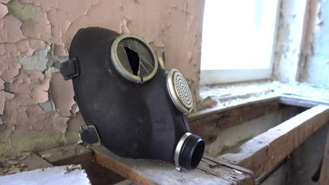 Chernobyl zone, Ukraine - 18th of June 2017: Visit to Duga radars (Soviet over-the-horizon radar system)- 4K Gas mask with broken eyeglass in administrative building of Duga
