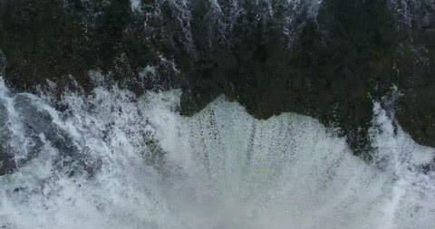 Traveling Shot Down Waterfall Plunge Into Green Canyon With White Water - Aerial Footage of Skogafoss Falls