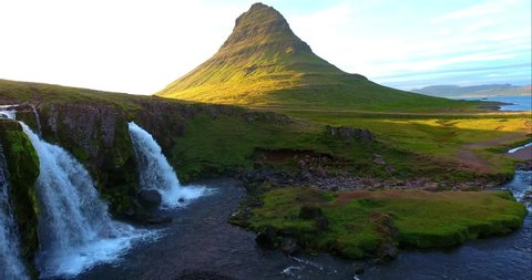 Green Mountain Peak With Dual Waterfalls - Aerial footage of the Kirkjufellsfoss Falls in Iceland