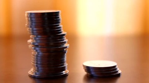 Cheap vs. expensive, coins on a desk, savings, choice
