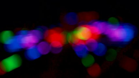 blurred spiral flashing neon night light bokeh in various rhythm flashing many colors 
