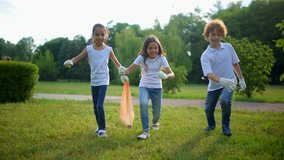 Excited children running fast with garbage bag in hand