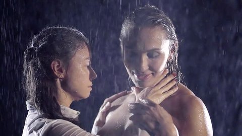 Homosexual couple, gay, young lesbians, same-sex marriage relationship between the happiest girl in the shower stall. Naked sexy lesbians enjoy caressing, under the jets of water in the dark