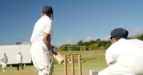 Bowler delivering ball during match on cricket field