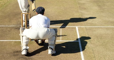 Bowler delivering ball during match on cricket field