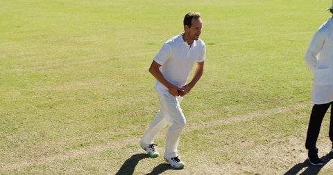 Caucasian bowler delivering ball during match on cricket field