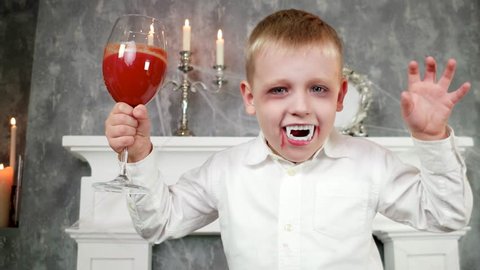 vampire boy, child in dracula costume with glass of blood, halloween costume, dangerous child,