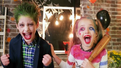 harley quinn and joker screaming, kids having fun at halloween party, crazy characters, spooky makeup,