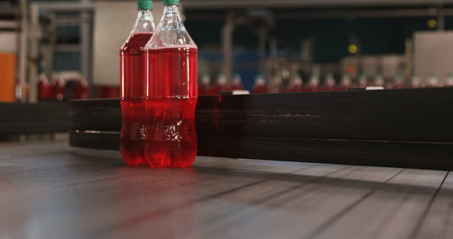 Packed bottle moving on conveyor belt in bottle factory