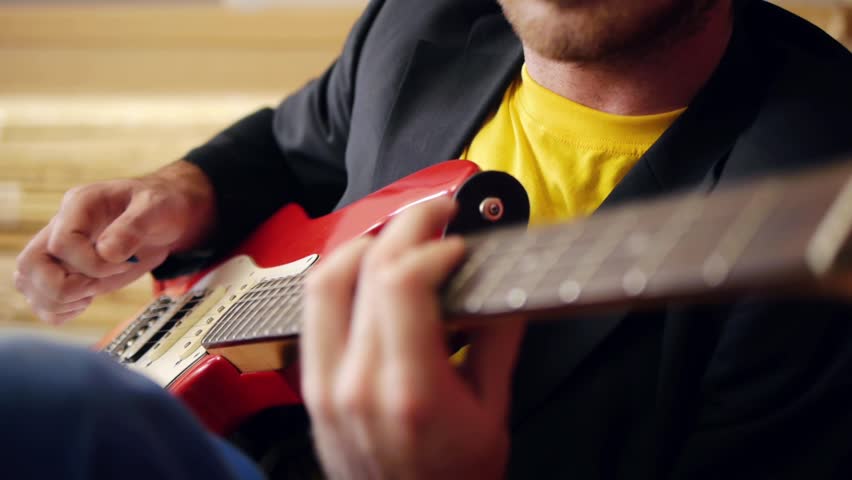 Musicians hands playing song on electric guitar