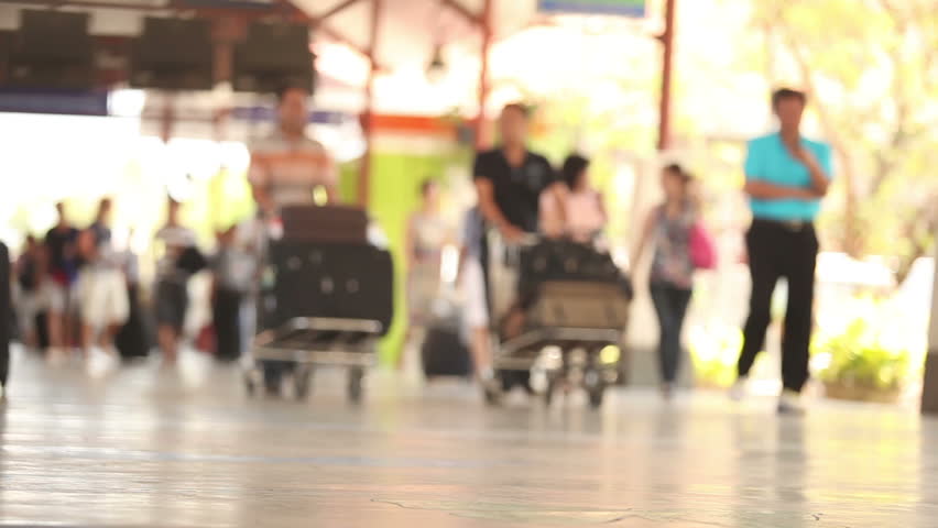People with baggages walking to near airport