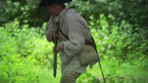 NEW ENGLAND - APRIL 2015 - Reenactment, large-scale, epic American Revolutionary War anniversary recreation, midst of battle. American Continental Rifleman / Militia with Rifled Musket aims and fires.