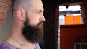 Man tilts his head to the side and stretching neck. Young bearded man doing workout. Full HD 1080p cinematic video