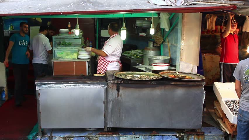 ISTANBUL - OCT 1: Man frying anchovies (Hamsi Tava) at Karakoy fish market on