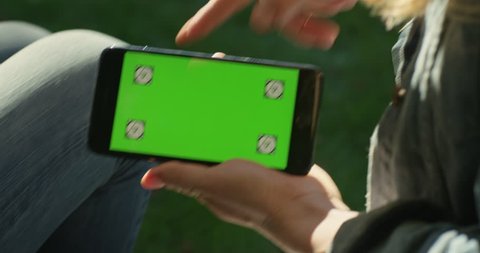 Women Using Smart Phone with Green Screen Tracking Markers