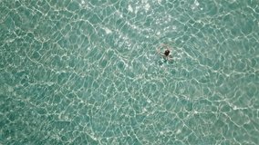 Beautiful woman swimming in transparent sea
