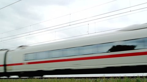 KAMPEN, THE NETHERLANDS: JUNE 7, 2012: German high speed ICE train (Intercity-Express) driving on a railroad track in the countryside.