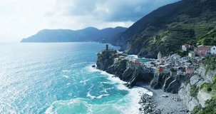 aerial view of travel landmark destination Vernazza,small mediterranean sea town,Cinque terre National Park, Liguria, Italy. Afternoon sunny and cloud weather. 4k slow motion 60 fps drone orbit video