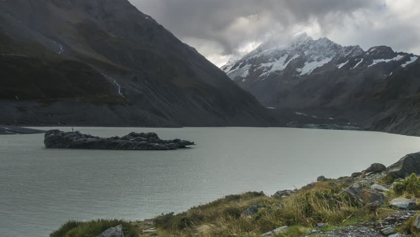 Time Lapse - Clouds moving at Mount Cook with Hooker Lake as foreground. Captured during rain, water droplets on lens. Camera pan right