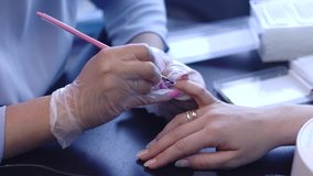 Manicurist treats nails. Closeup shot.