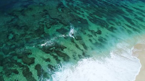 Man surfing over amazing reef patterns