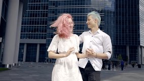 happy and crazy young people with dyed hair. the boy with blue hair and pink girl. they are happy together