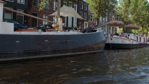 Boat tour through the beautiful canals of Amsterdam - AMSTERDAM / NETHERLANDS - JULY 20, 2017