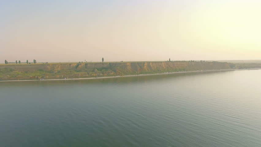 Aerial view of people sunbathing and swimming on wild beach