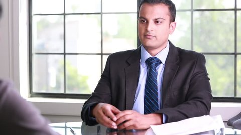 Closeup portrait, guy in suit blazer and tie giving delivering good news to employee, isolated windows background. Positive emotions facial expressions body language