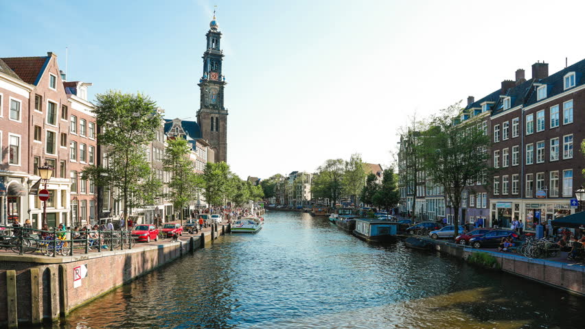 A view of the canal and the Westerkerk Tower from Leliegracht, Amsterdam.  
Westerkerk is the Renaissance-era protestant Church where Rembrandt is buried. 1600s church with iconic 85m tall spire.

