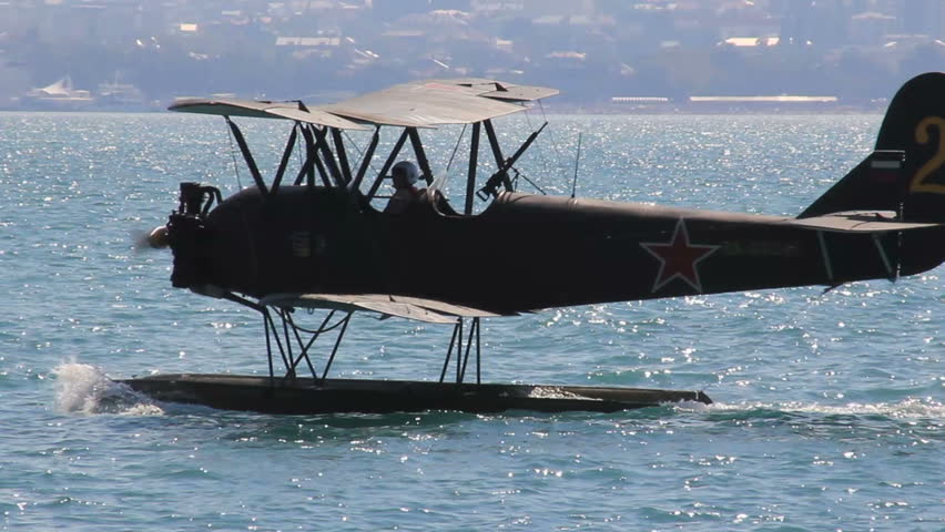 Old hydroplane float on water surface of harbor