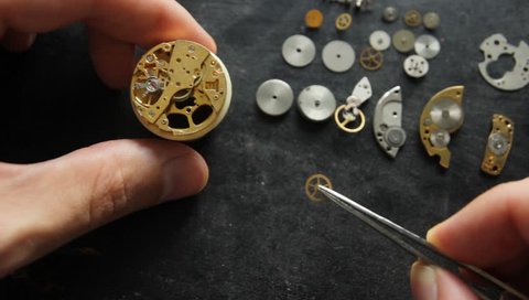 Watchmaker is repearing a mechanical watches