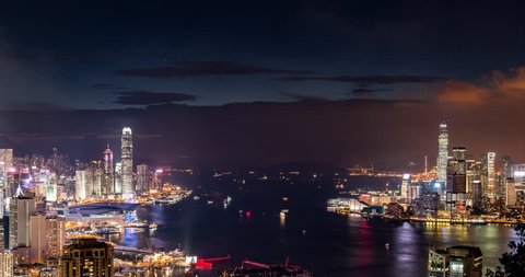 night cityscape of Hong Kong, with moving ships and city lights