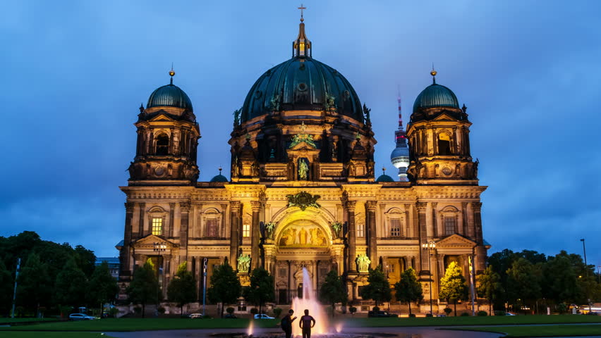 Berlin, Germany. View of Evangelical Cathedral located on the Museum Island in Berlin, Germany. Time-lapse at sunset with dark cloudy sky. Zoom in