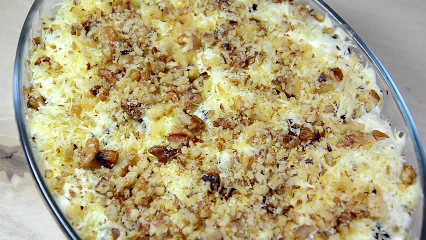 Fish salad with cheese, prunes, nuts
