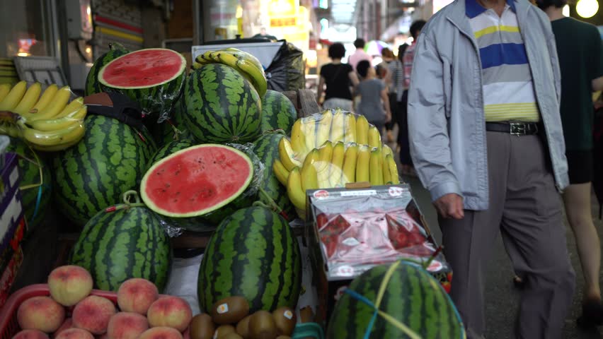 4K A traditional cart hawker selling fruit in the street of Gukje International Market Busan. Korean vendors sell food with easily transported in South Korea-Dan