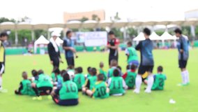Blurred Video Coaches are training youth football, Meetings Young children football Practice groups in stadium camp