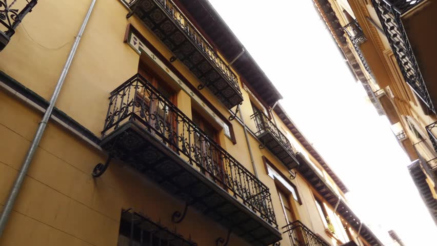 Calle San Pedro Martir in Granada. Granada is city in autonomous community of Andalusia, Spain, located at foot of Sierra Nevada mountains, on rivers Beiro, Darro, Genil and Monachil.