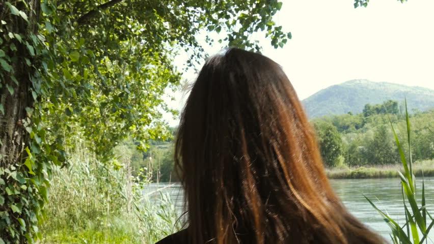 Young Beautiful Woman on a Footpath Towards the Lake in Summer, Seen From Behind