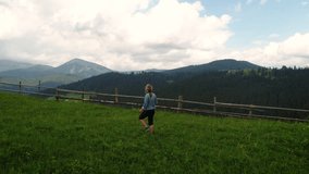 Woman making photo of summer meadow