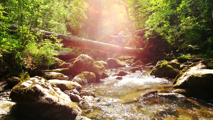 Man in VR glasses on the background of a mountain river