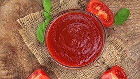 Portion of Tomato Ketchup rotating on a wooden plate (not loopale; 4K)
