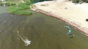4K Aerial drone footage. Kitesurfer riding near coast