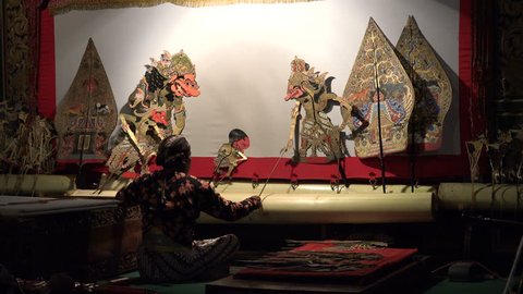 YOGYAKARTA, INDONESIA - APRIL 2017: Backstage view of shadow puppet player during Wayang Kulit show in Yogyakarta, Indonesia