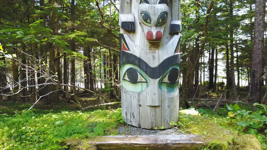 Totem Pole sitting in the rainforest of the Haida culture on Prince of Wales Island, Alaska. Filmed by pilot using drone from base to top under FAA 107 exemption for commercial use.